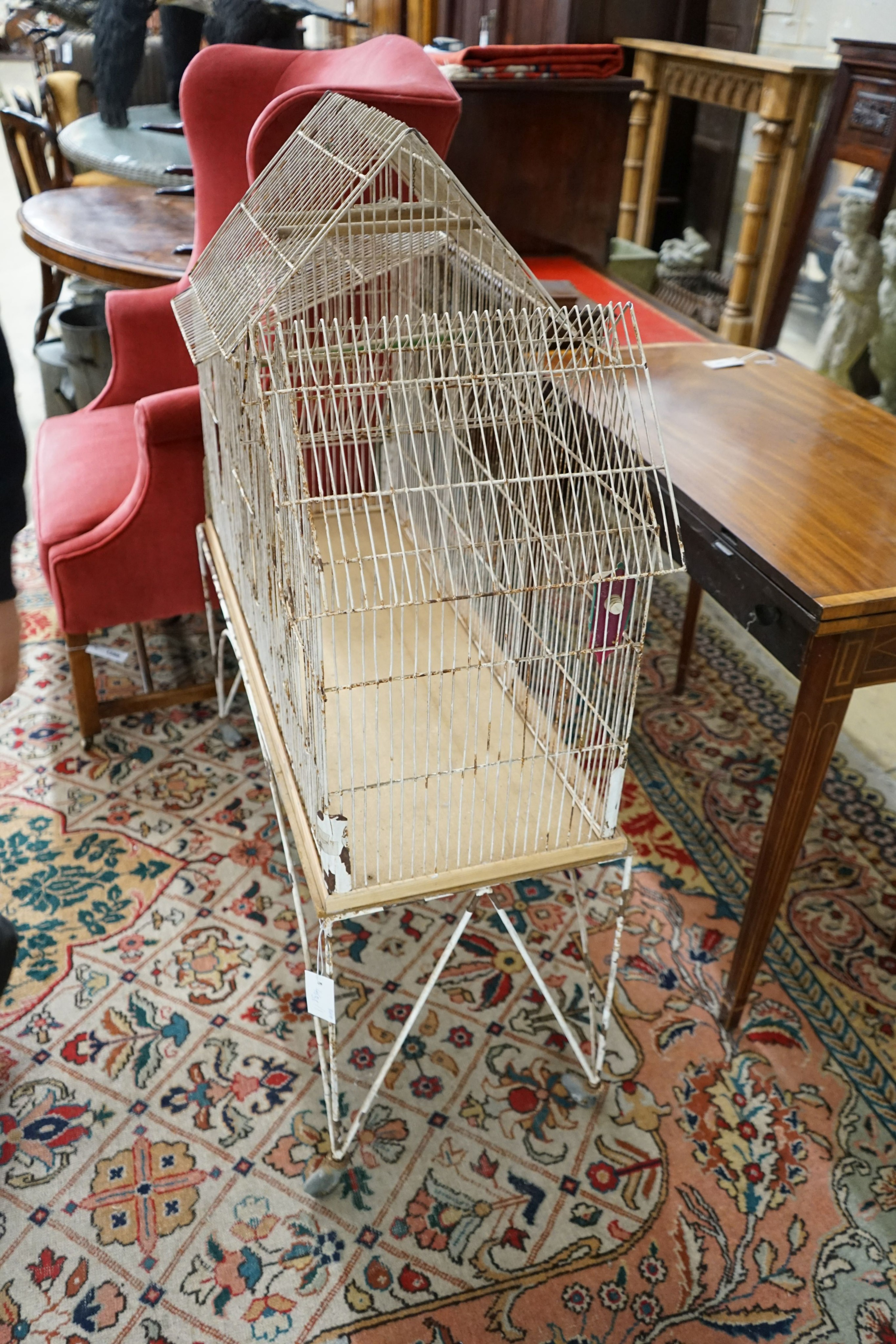 A painted wirework bird cage on stand, width 99cm, depth 36cm, height 117cm